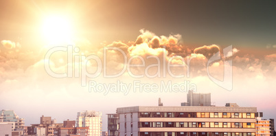 Composite image of scenic view of bright orange sun over clouds during sunset