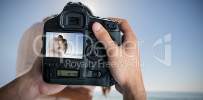 Composite image of cropped image of hands holding camera