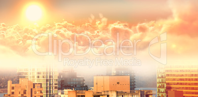 Composite image of scenic view of bright orange sun over cloudscape during sunset