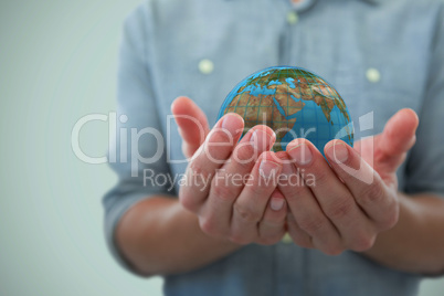 Composite image of cupped hands of man holding invisible object