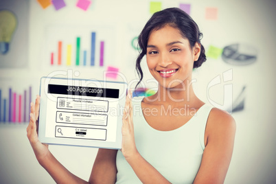 Composite image of happy businesswoman showing digital tablet in creative office