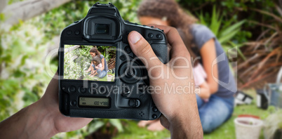 Composite image of cropped image of hands holding camera