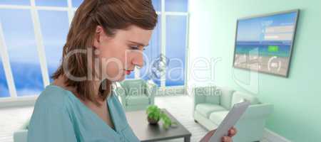 Composite image of businesswoman looking at tablet