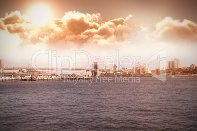 Composite image of scenic view of bright sun over clouds