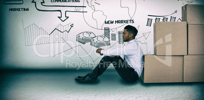 Composite image of businessman leaning on cardboard boxes against white background