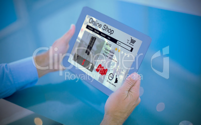 Composite image of businessman using his tablet