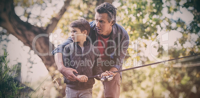 Father and son fishing in forest