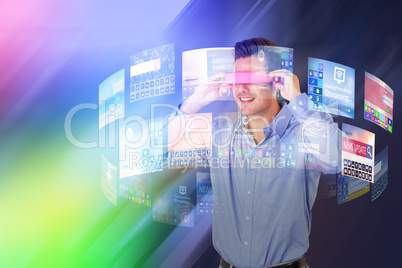 Composite image of happy young man using virtual video glasses