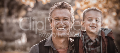 Portrait of father and son in forest