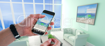 Composite image of close-up of man holding mobile phone