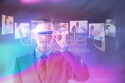 Composite image of handsome businessman virtual reality glasses