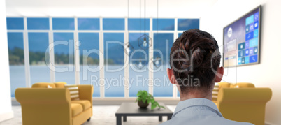 Composite image of rear view of businesswoman sitting on chair