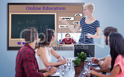 Composite image of casual businesswoman giving presentation to her colleagues