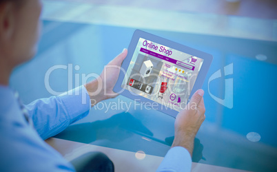 Composite image of businessman using his tablet