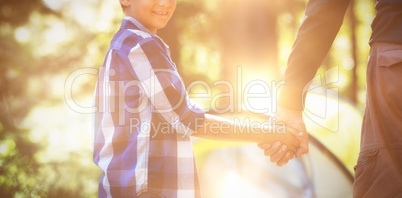 Smiling boy with father camping in forest