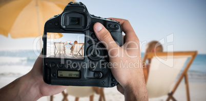 Composite image of cropped image of hands holding camera