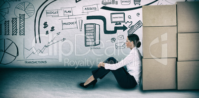 Composite image of businesswoman leaning on cardboard boxes against white background