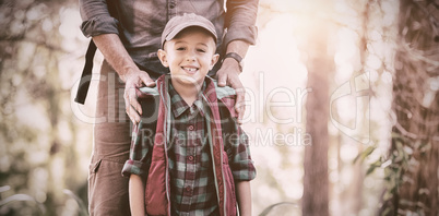 Portrait of happy boy standing with father