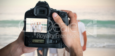 Composite image of cropped image of hands holding camera