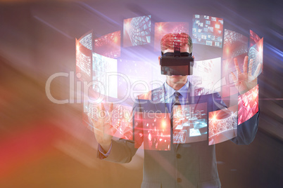 Composite image of businessman using virtual reality headset