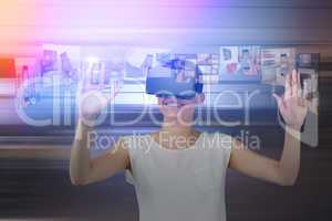 Composite image of happy woman gesturing while using virtual reality headset