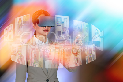Composite image of businesswoman gesturing while wearing virtual video glasses