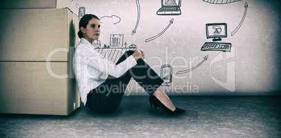 Composite image of businesswoman leaning on cardboard boxes against white background