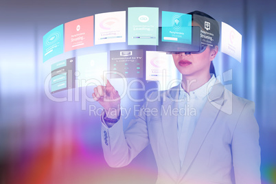 Composite image of businesswoman gesturing while wearing virtual video glasses