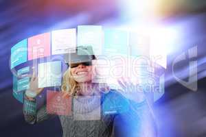 Composite image of cheerful young woman using reality virtual headset