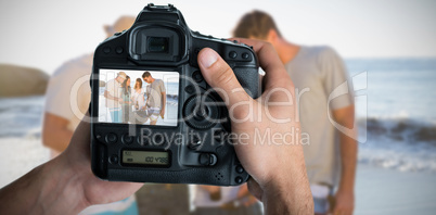 Composite image of cropped image of hands holding camera