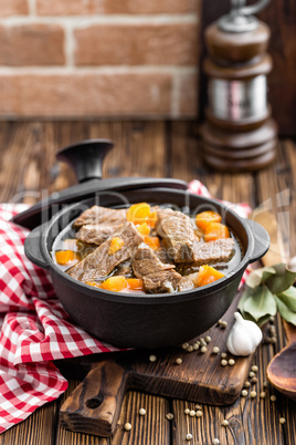 Delicious braised beef meat in broth with vegetables, goulash