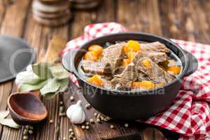 Delicious braised beef meat in broth with vegetables, goulash