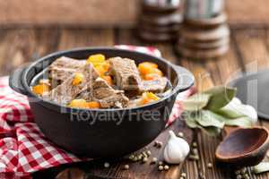 Delicious braised beef meat in broth with vegetables, goulash