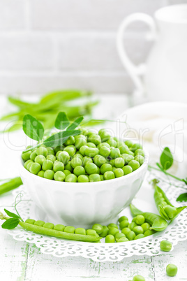 Green peas with leaves on white background