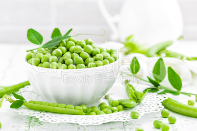 Green peas with leaves on white background