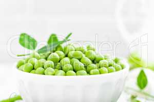 Green peas with leaves on white background