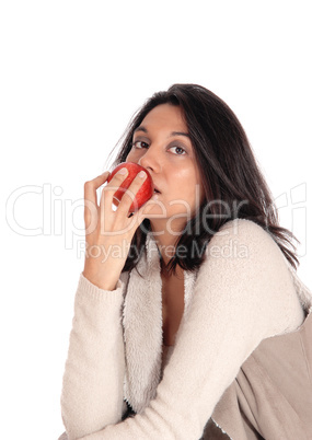 Woman eating red apple.