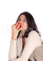 Woman eating red apple.