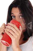 Beautiful Hispanic woman with red mug.