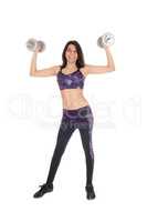 Beautiful woman lifting dumbbells.