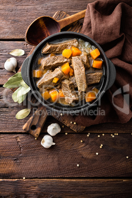 Delicious braised beef meat in broth with vegetables, goulash