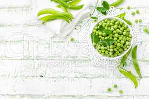 Green peas with leaves on white background