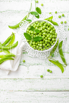 Green peas with leaves on white background