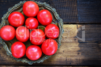 Ripe red tomatoes in an iron plate