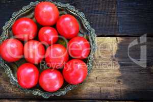 Ripe red tomatoes in an iron plate