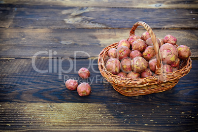 Raw potatoes in a wicker basket