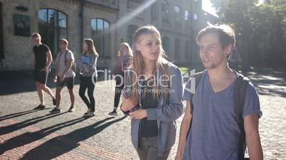Attractive couple of students walking on campus