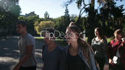 Smiling students going to lecture at college