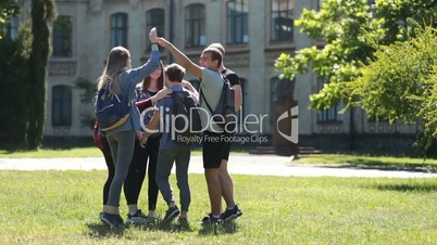 Diverse group of students gathering on park lawn