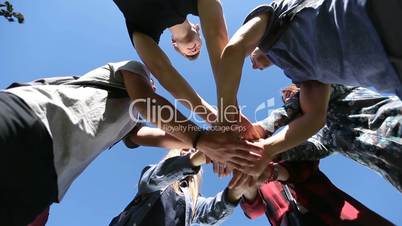 Team of friends showing unity joining hands